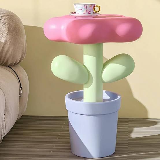 Kawaii pastel flower shaped bedside table in soft pink beside a bed